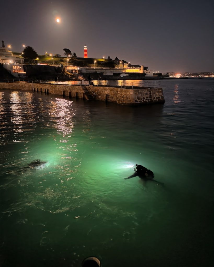 Scuba divers diving from the waterfront in Plymouth Sound